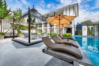 Loungers and an iron pavilion beside the hotel pool