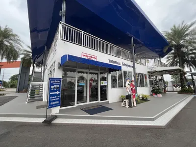 Cafe built as an airport terminal with a check-in counter sign and cabin-crew mannequins