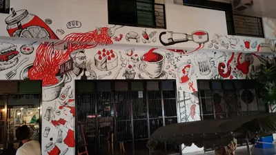 Red and black food mural covering the wall above the restaurant's shutters