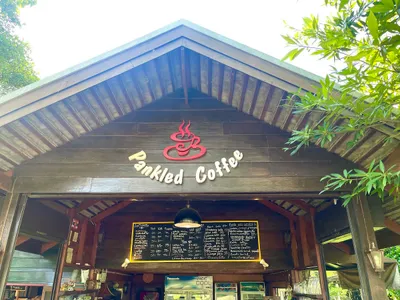 Timber gable with the Pankled Coffee sign above a chalked drinks board