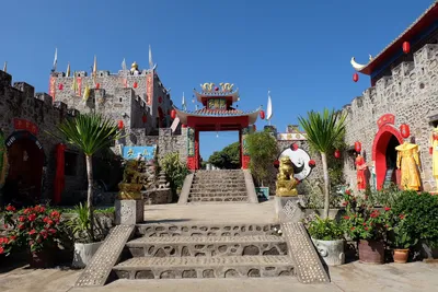 Stone walls, red lanterns and a Chinese gateway at the village entrance