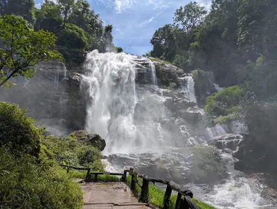 Waterfall in full spate throwing spray across the walkway below